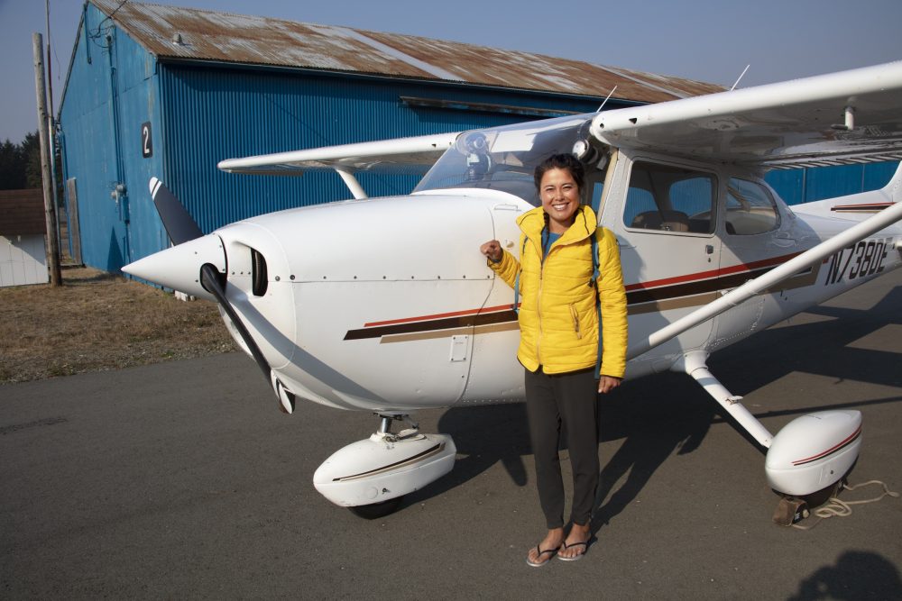 Alaskan Native, Ariel Tweto, stands in front of the Cessna 172 that she piloted along the southern Oregon Coast