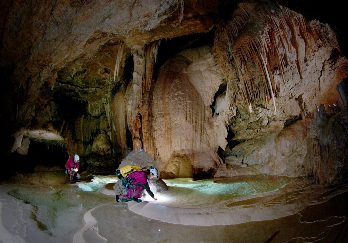 cave experts viewing pool inside cave