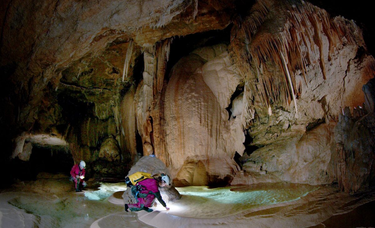 cave experts viewing pool inside cave