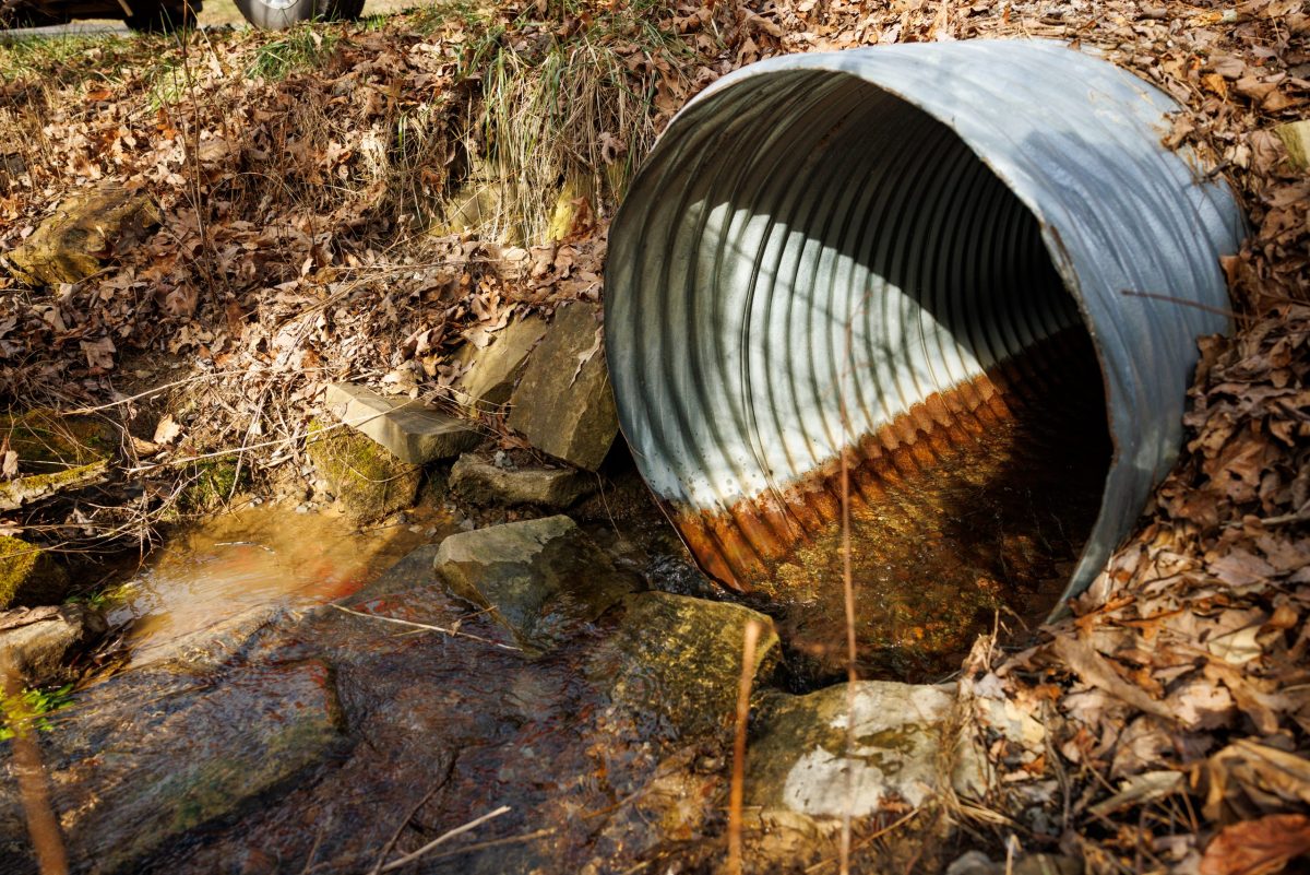 Water flows through a problematic culvert that does not allow for the passage of fish upstream