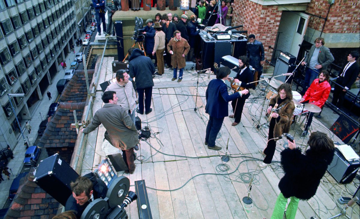 The Beatles perform on a rooftop