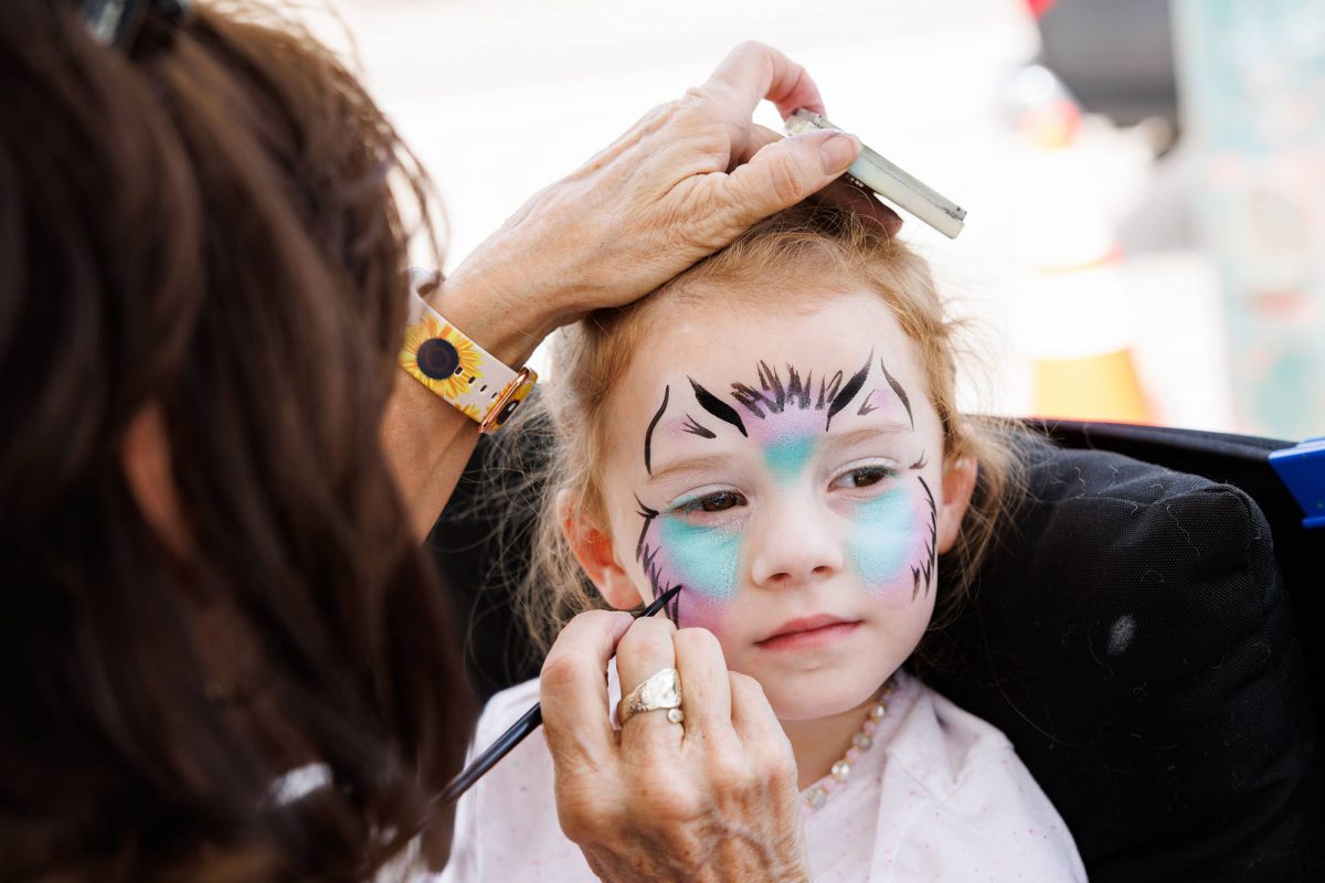 A child has their face painted