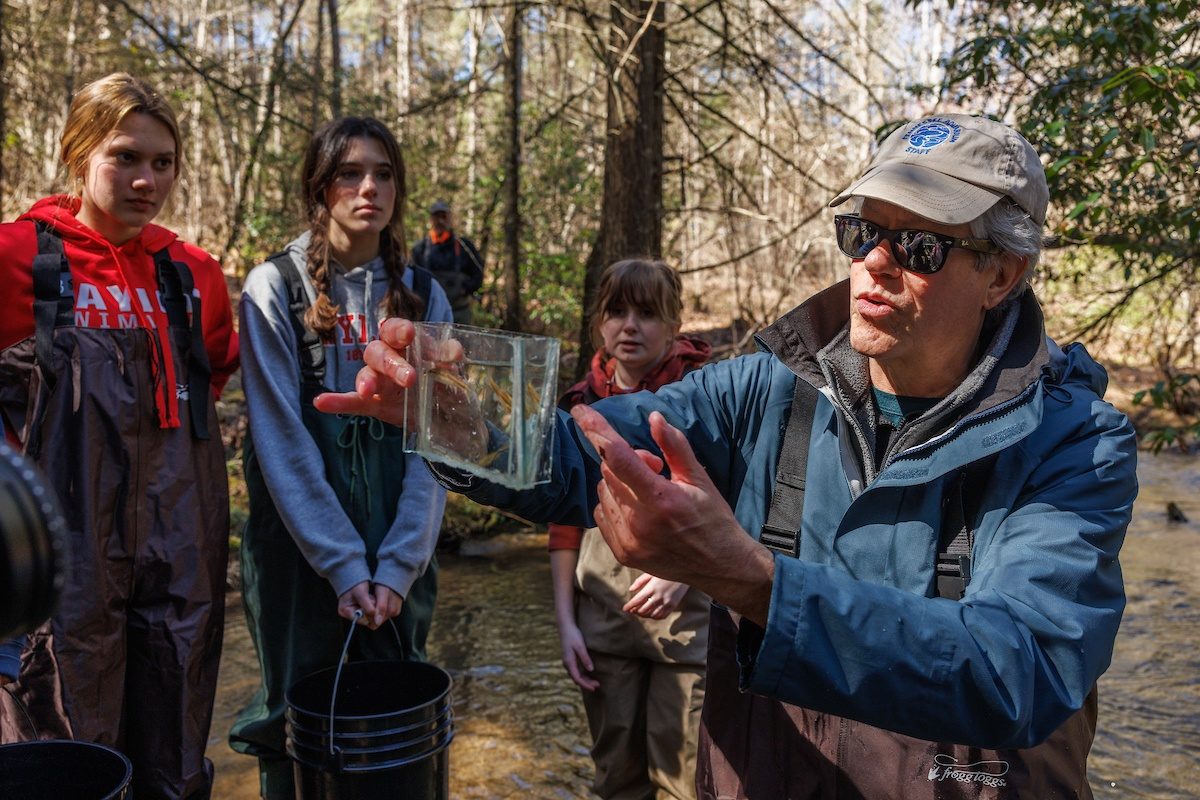 Aquatic Conservation Biologist Dr. Bernie Kuhajda shows a Laurel Dace to Baylor School environmental research students at Bumbee Creek in Rhea County, Tenn. The group accompanied scientists from the Tennessee Aquarium Conservation Institute as they conducted research on Laurel Dace and Eastern Blacknose Dace.