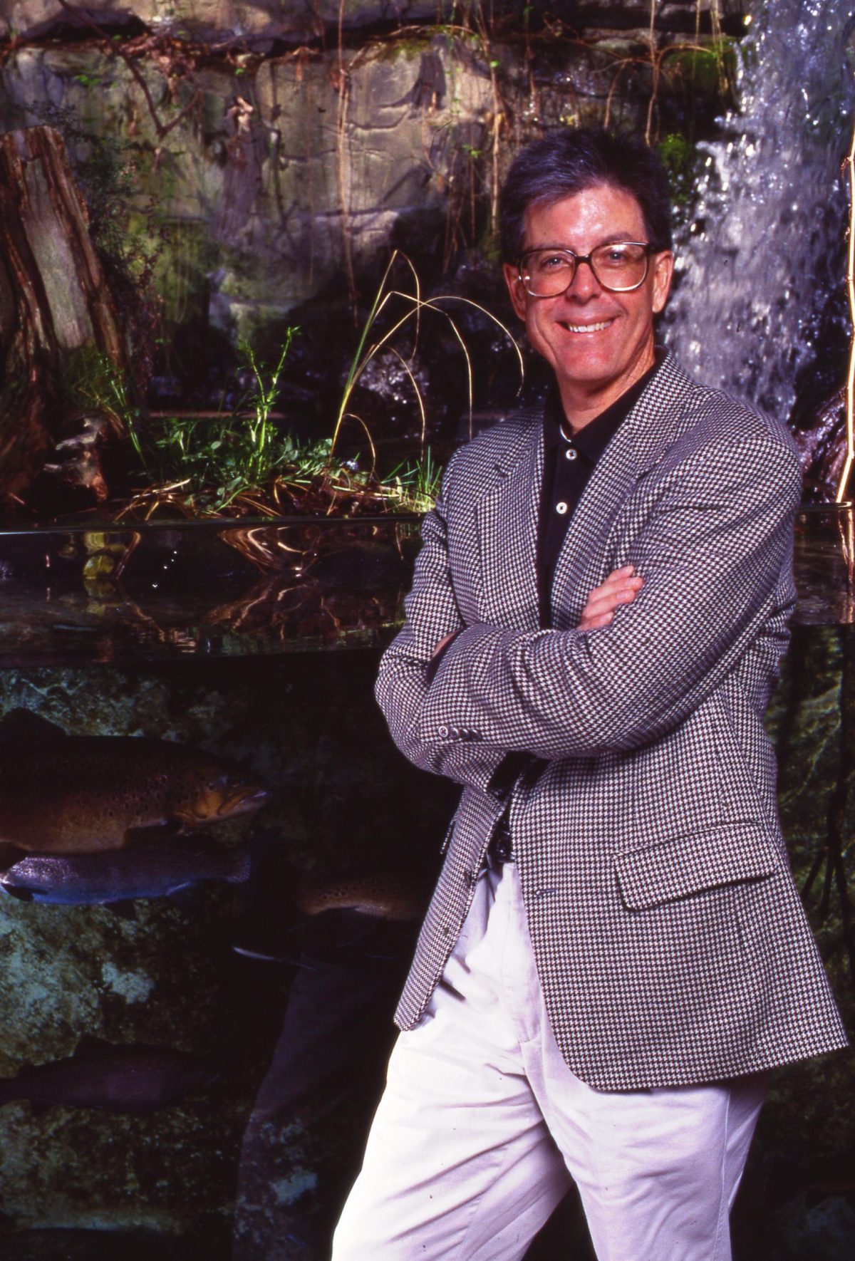 Jackson Andrews poses next to the Alligator Bayou exhibit in the Tennessee Aquarium