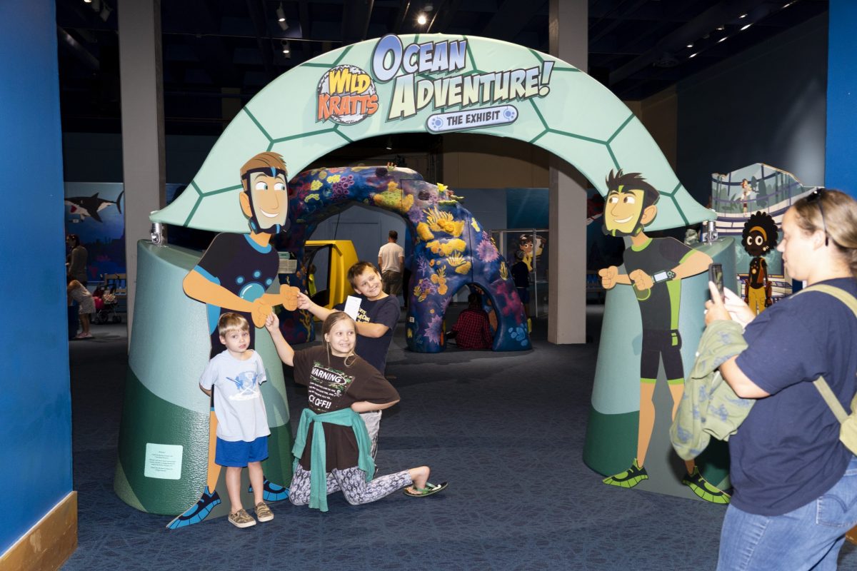 family in front of Wild Kratts exhibit