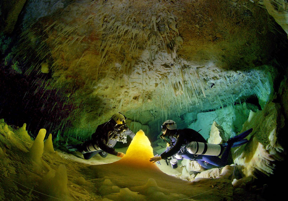 Research divers Brian Kakuk and Todd Kelly examine a “Christmas Tree” stalagmite in the crystal section of the Crystal Cave of Abaco, Bahamas.