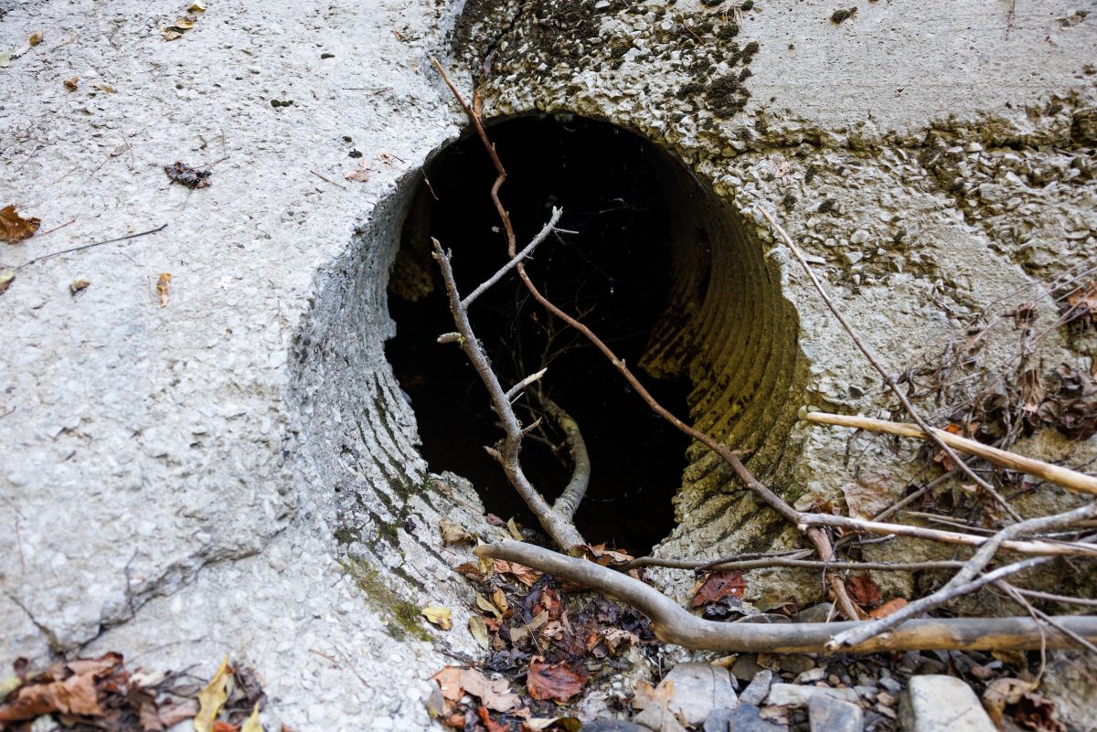 A hole left behind by a metal culvert that has flowed downstream