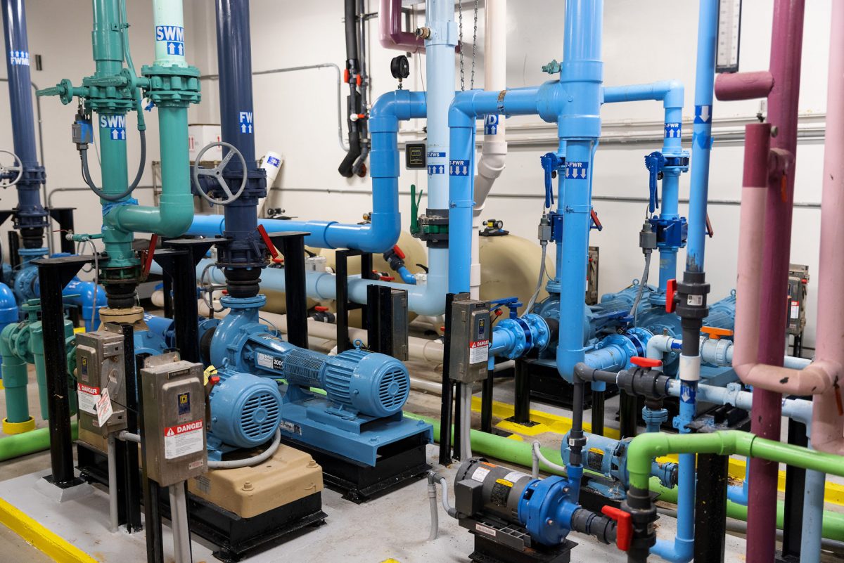 Pipes connect into many pumps in a room