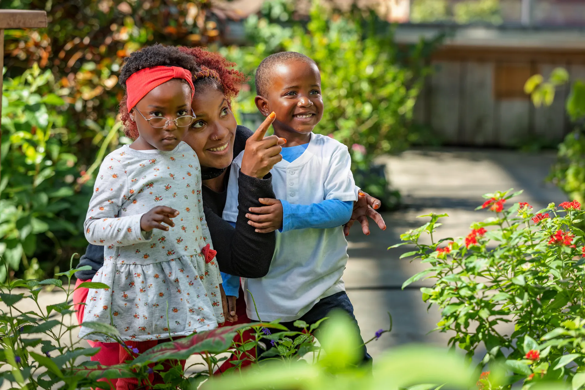 Three guests, one adult and two younger, enjoying the Butterfly Garden exhibit at the Tennessee aquarium
