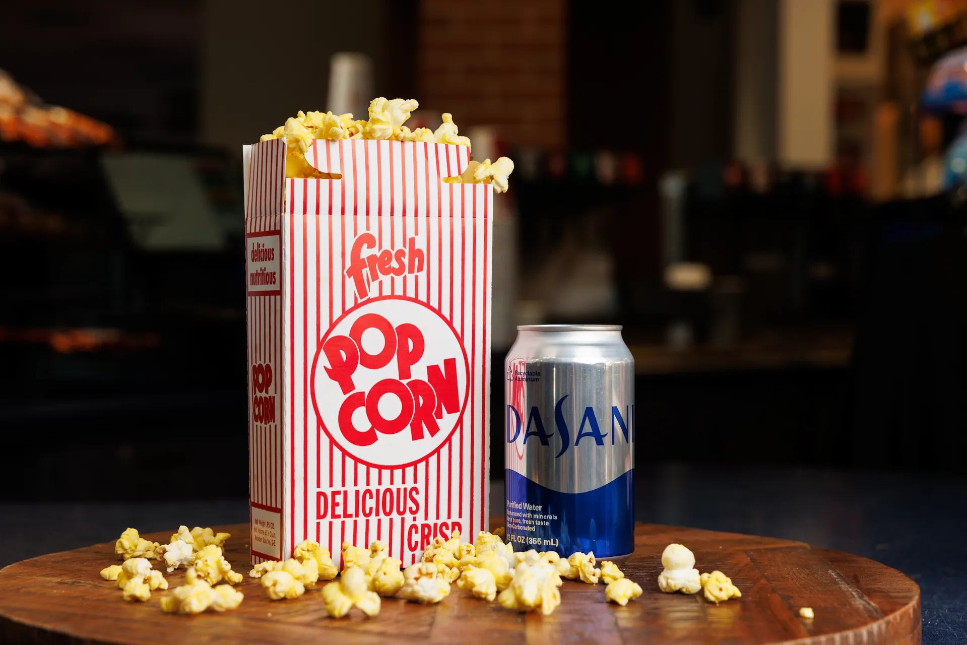 Snack pack option for group visits, including a box of popcorn and canned Dasani water
