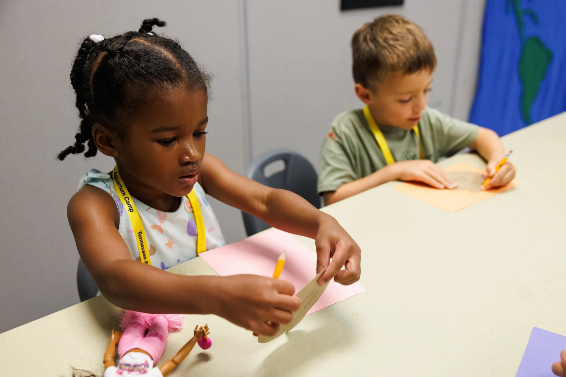 Two Aquarium campers working on a craft activity next to each other