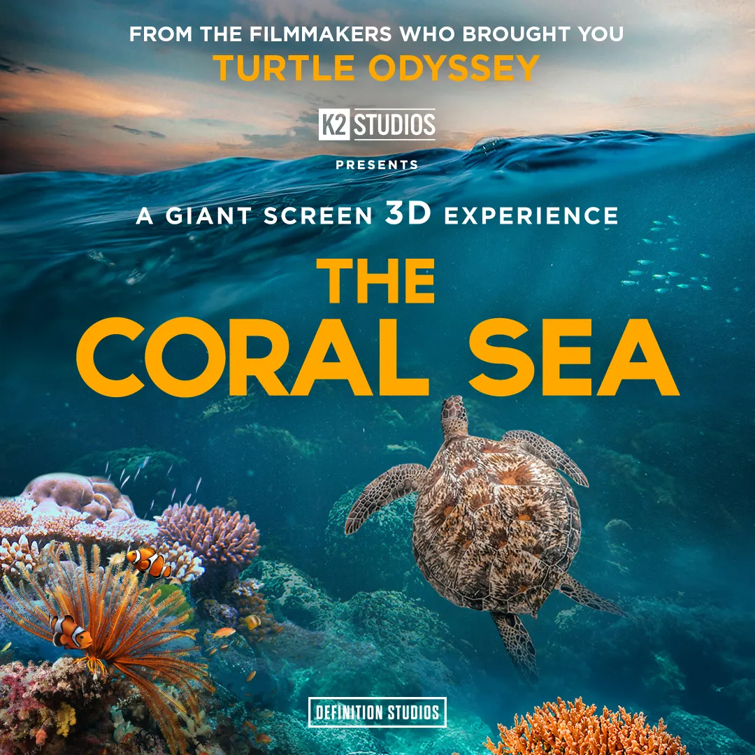 A sea turtle swimming in the ocean amongst coral with rocky mountains in the background, promotion for the Coral Sea 3D film