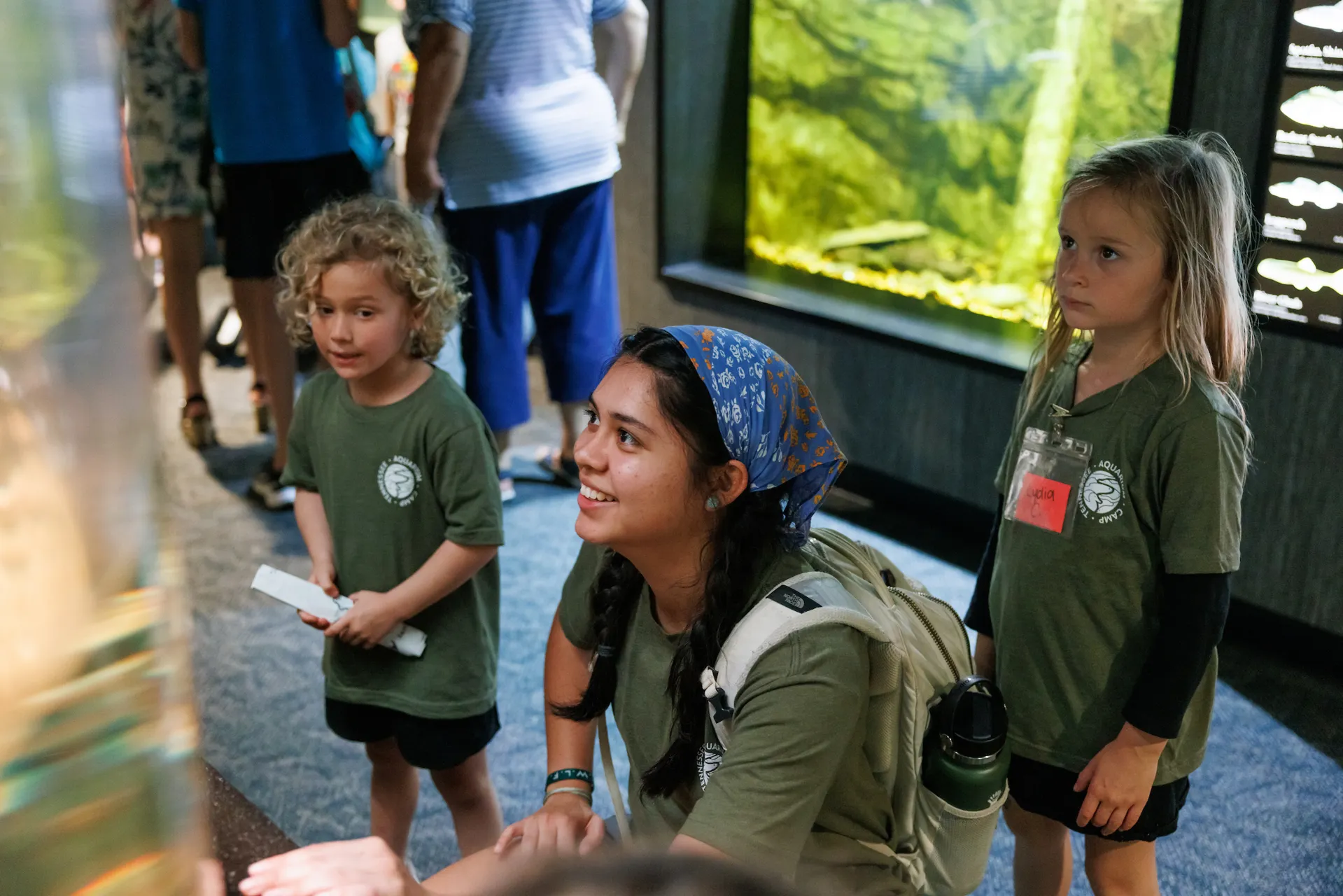 Aquarium summer camp counselor and campers in the Ridges to Rivers gallery
