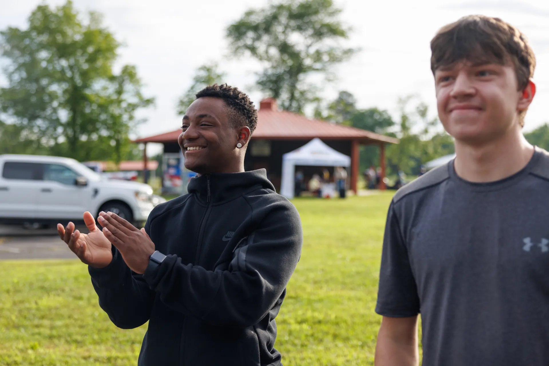 Two Laurel Dace Day event attendees cheering on race participants
