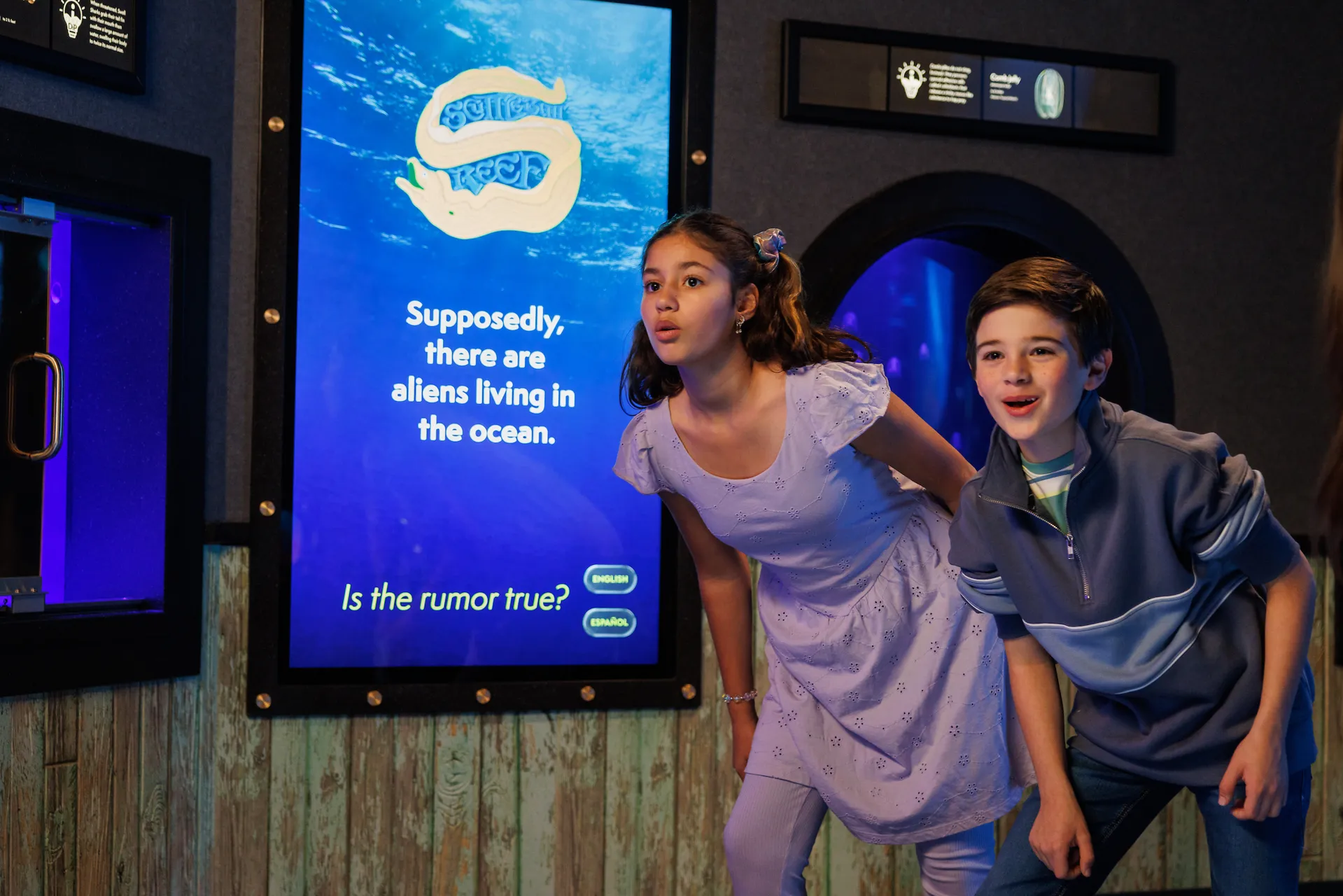 Two young guests looking curiously in the new Scuttlebutt Reef gallery at the Tennessee Aquarium