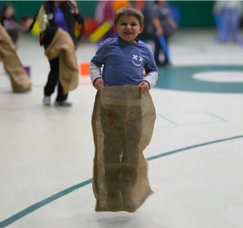 Student from Cecil B. Rigsby Elementary School swimming to the finish line.