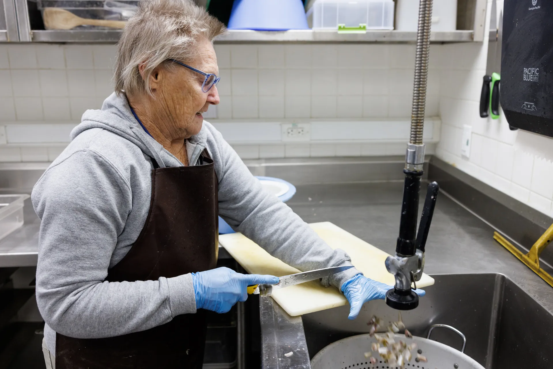 Volunteer Phyllis McAdams prepares food for the Secret Reef.