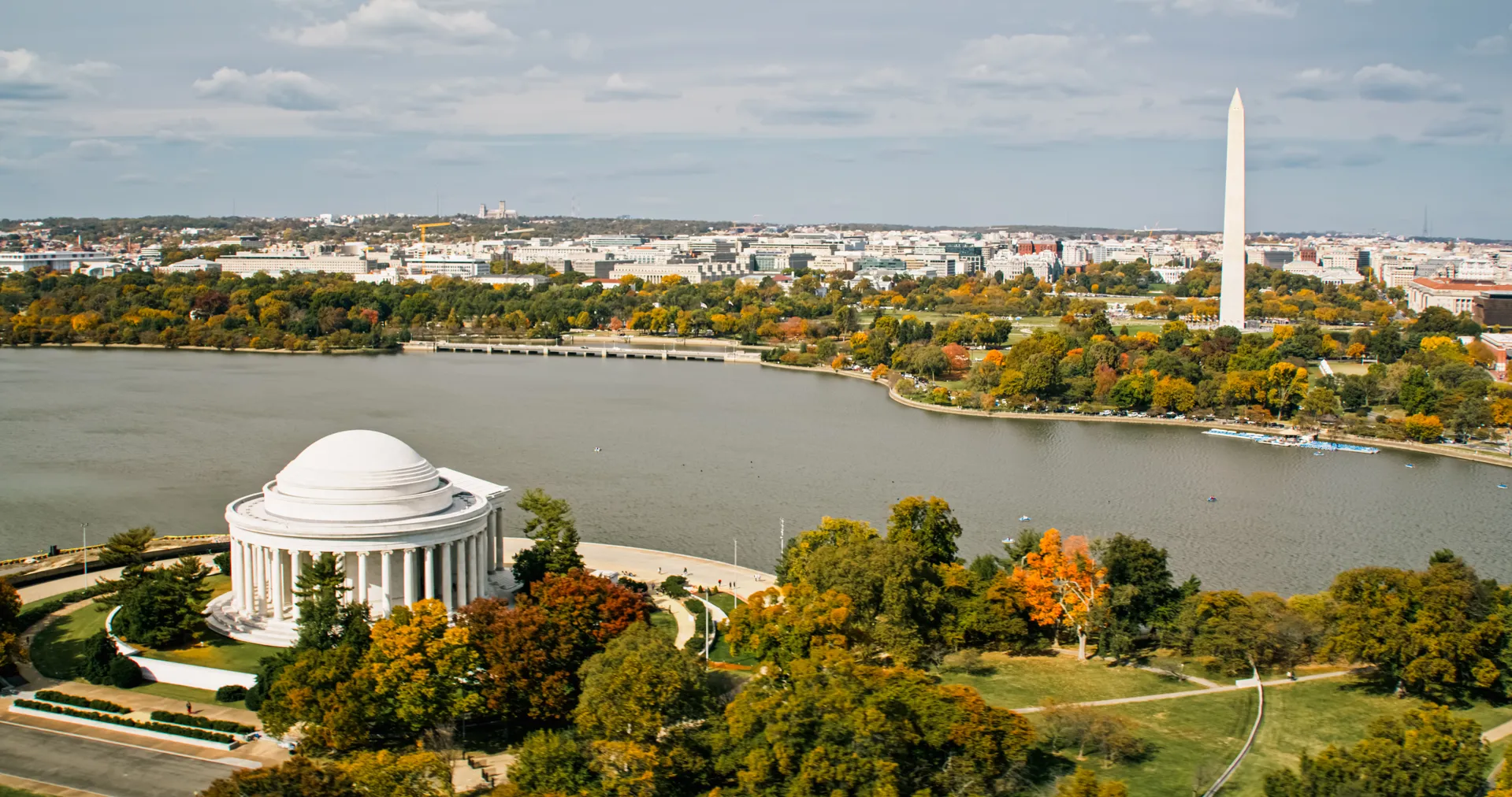 Fall is coloring the leaves of trees in Washington D.C. in an aerial view of the Potomac River. The Jefferson Memorial and Washington Monument are visible in this aerial view of the capital.