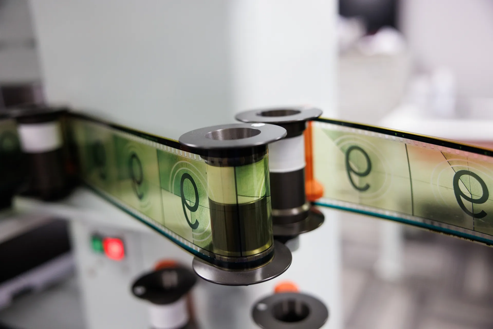 70mm IMAX film stretches between rollers in the process of being spooled