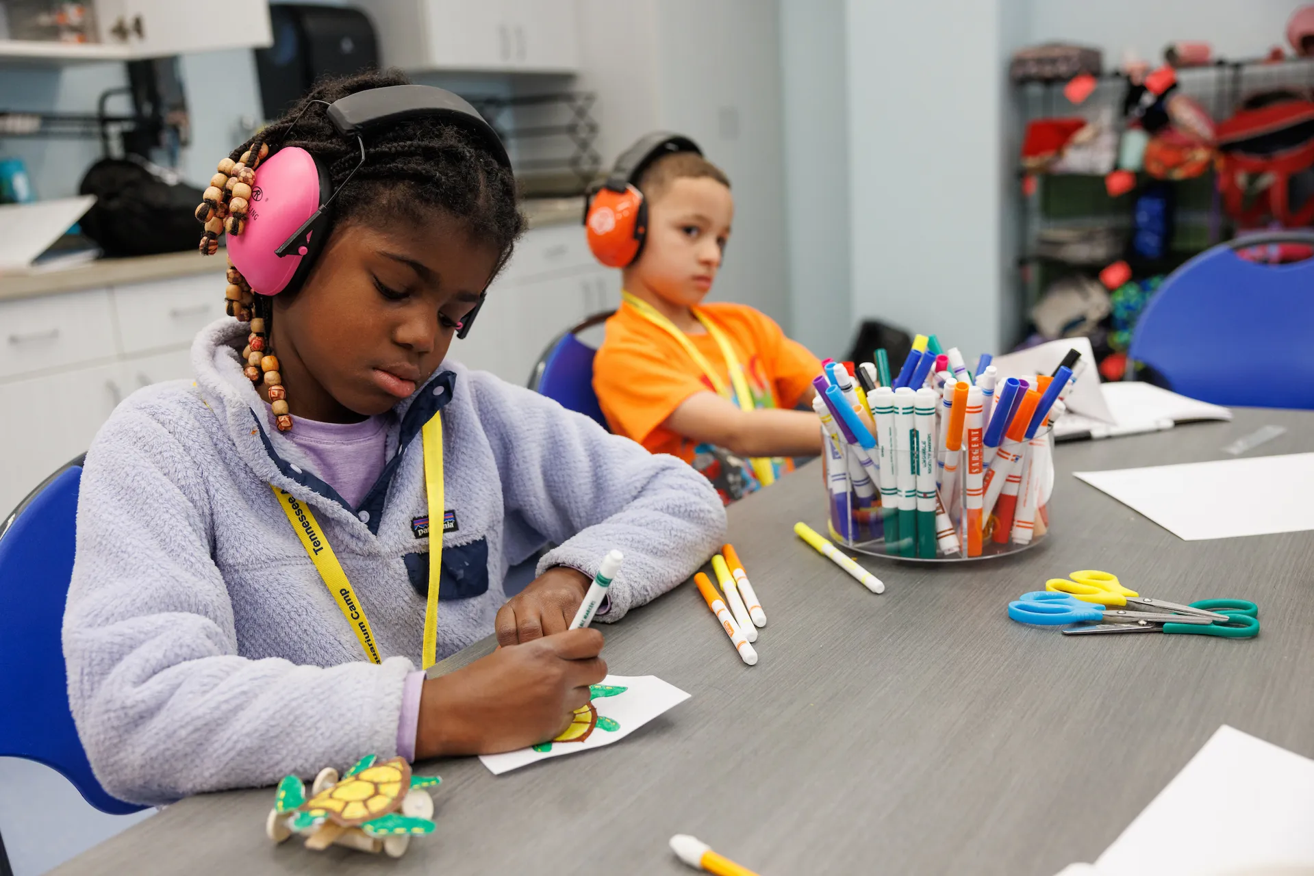 two Tennessee Aquarium campers participating in a coloring activity