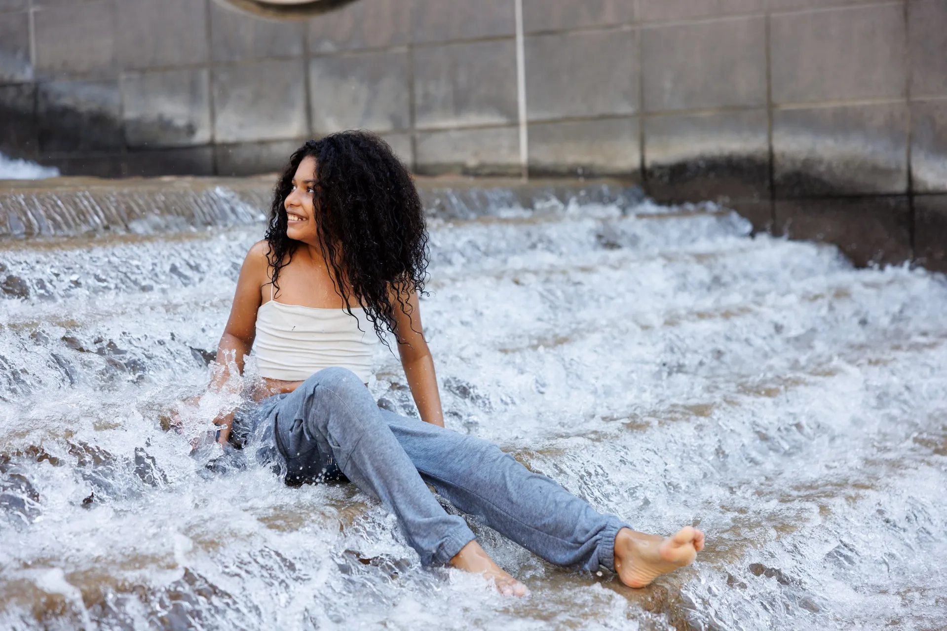 A visitor cools off in The Passage, a water feature and art installation memorializing the Trail of Tears. Labor Day offers one of the final opportunities for guests to experience these popular attractions before they cease operation for the year.
